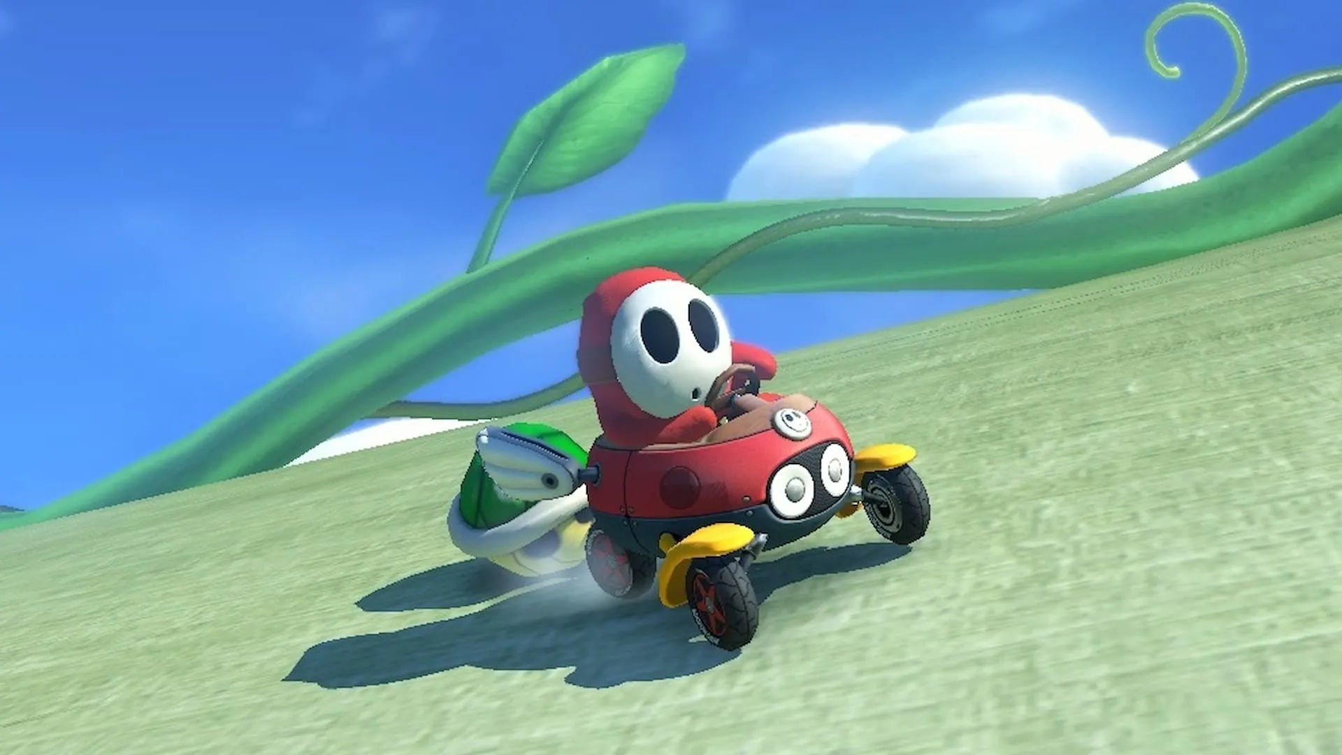 Red Shy Guy đang bị Rùa Xanh truy đuổi trong Mario Kart 8 Deluxe